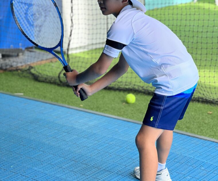 Kid enjoying Tennis on a tennis simulator