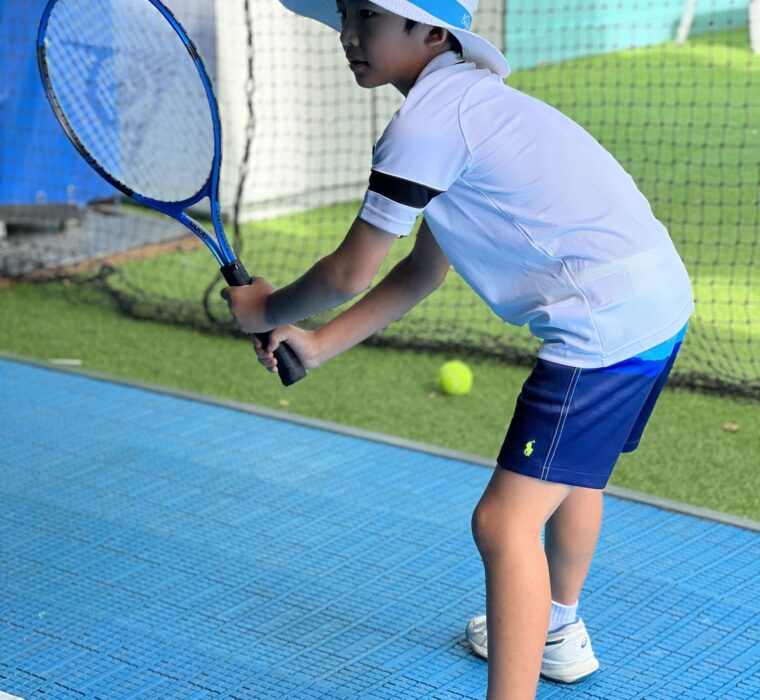 Kid enjoying Tennis on a tennis simulator